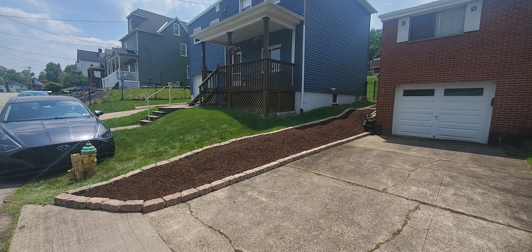 Hillside transformation into a low maintenance clean looking space in Verona, Pa.